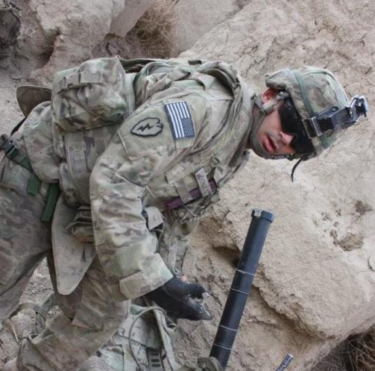 Ricardo Donato in Army combat gear beside a mortar system